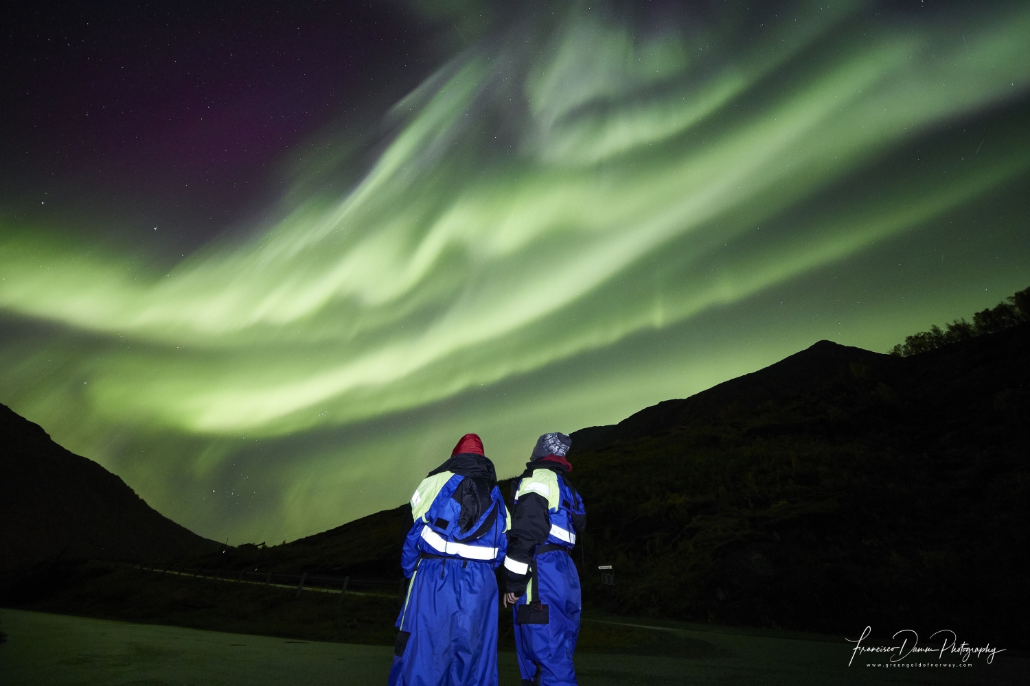 two people watching the northern lights