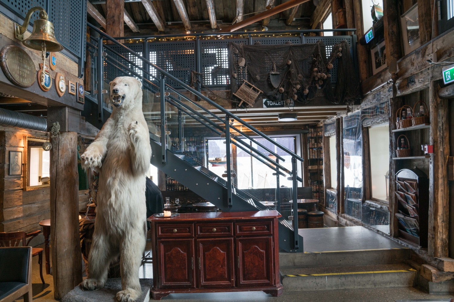 a room with decorations of a polar bear and old fishing stuff