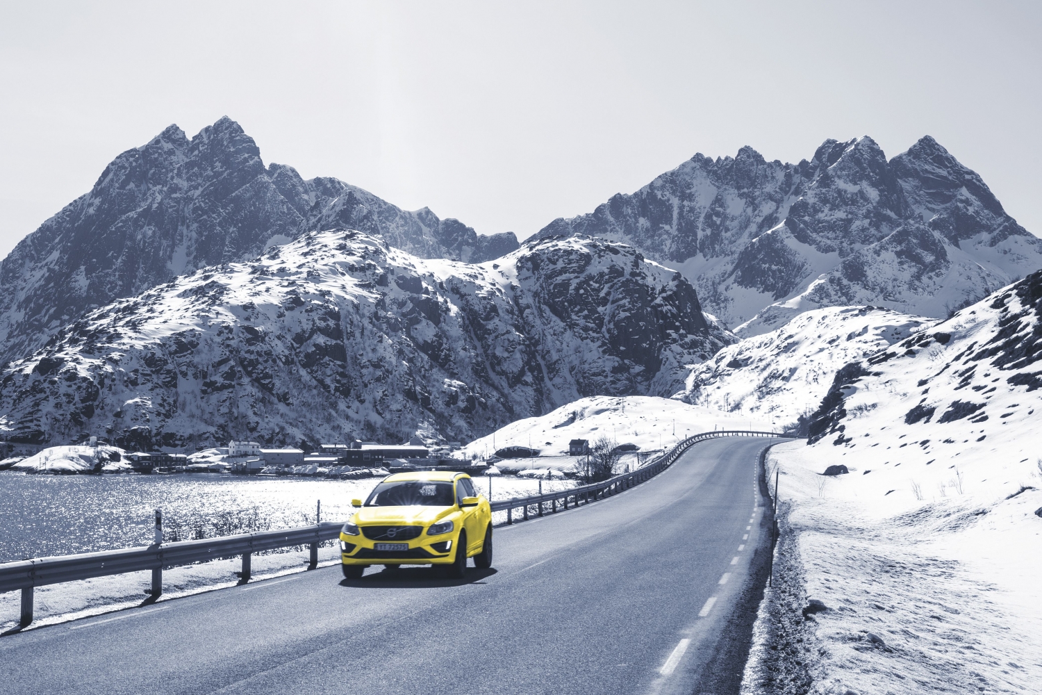 yellow car driving in wintertime by the sea
