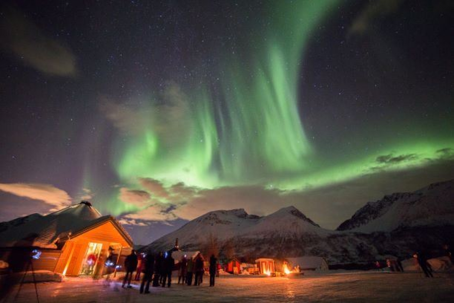 northern lights and base camp with people standing
