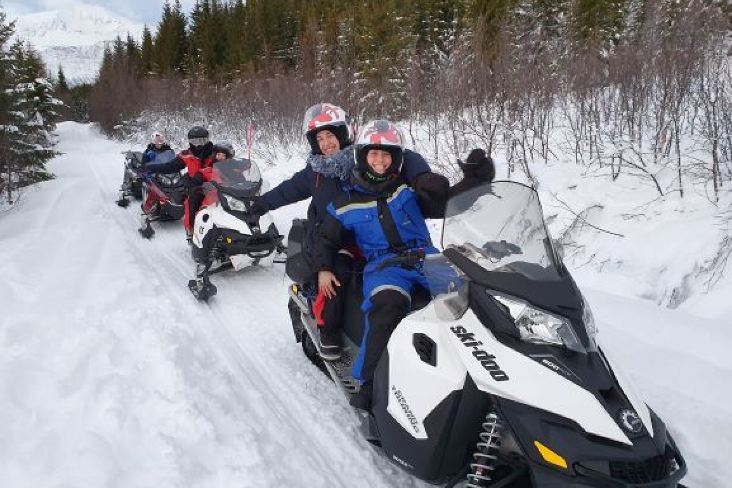 happy guests on their snowmobile safari