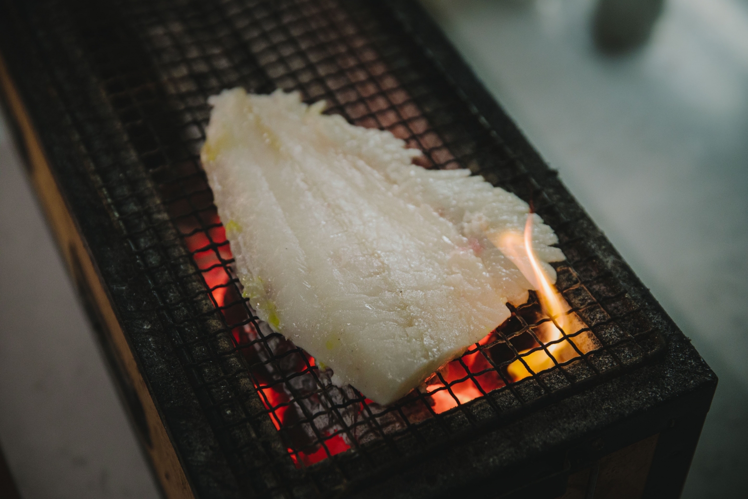 A piece of fish on a habachi grill