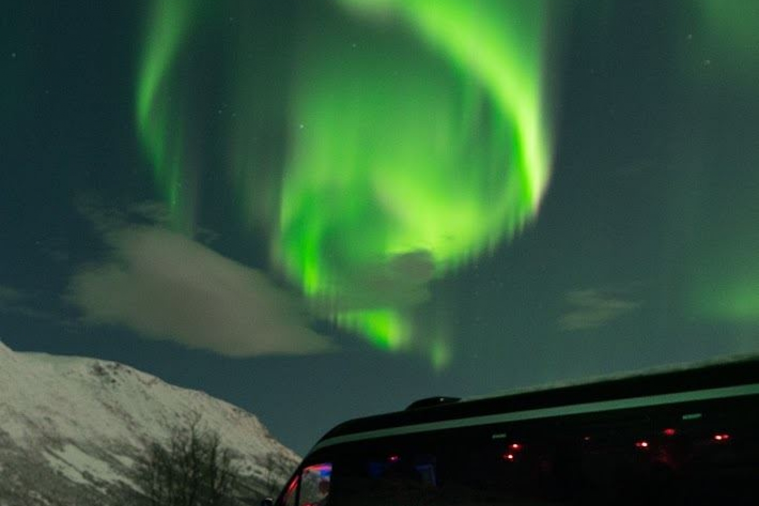 comfortable and modern minibus under the northern lights