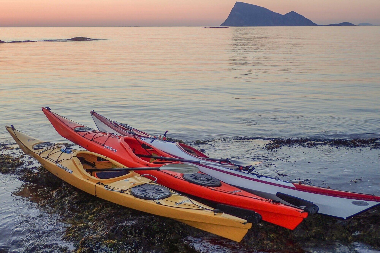 kayak on a beach with views towards the open sea and the mountain Håja