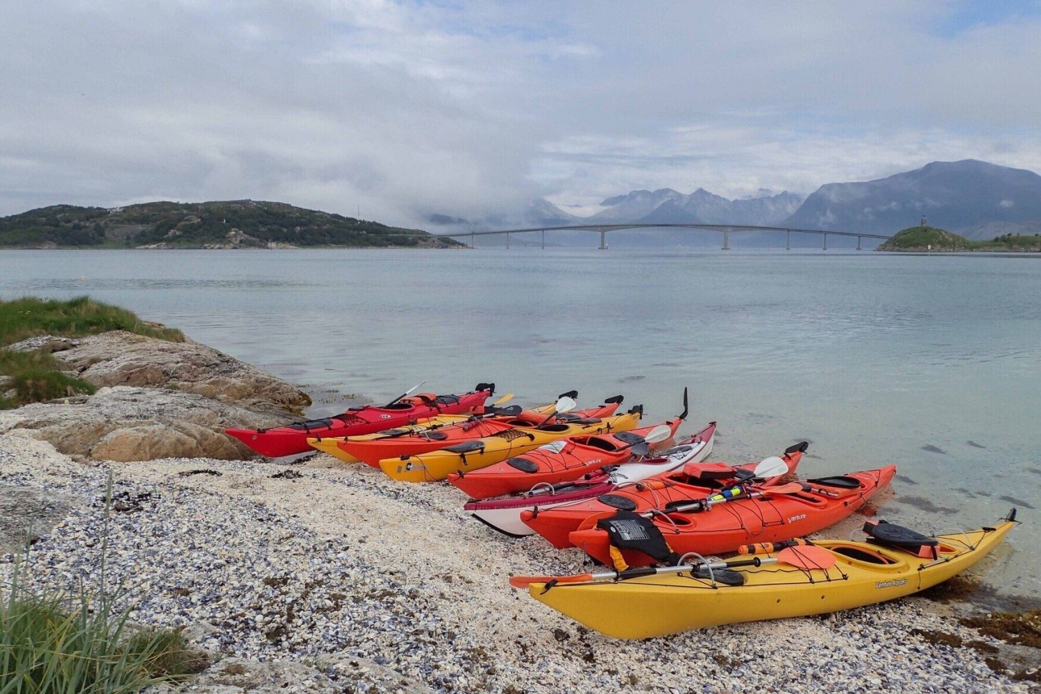 kayaks on a beach with views towards the bridge over to Sommarøy