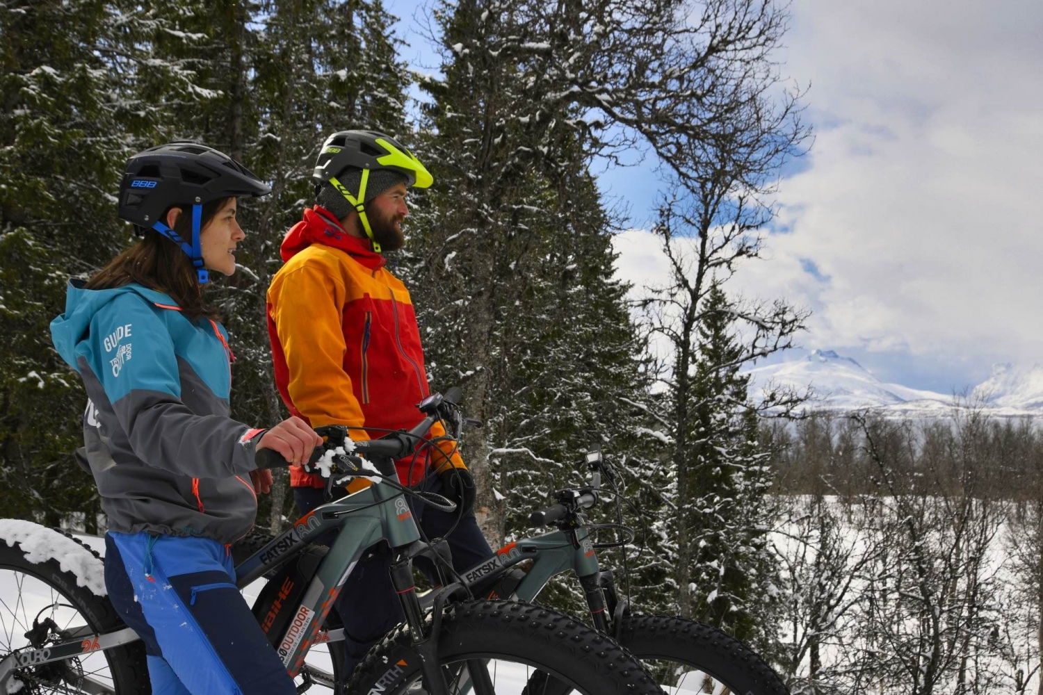 Two persons enjoying the view from their fatbikes
