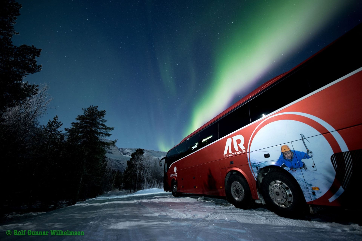 the arctic route bus under northern lights
