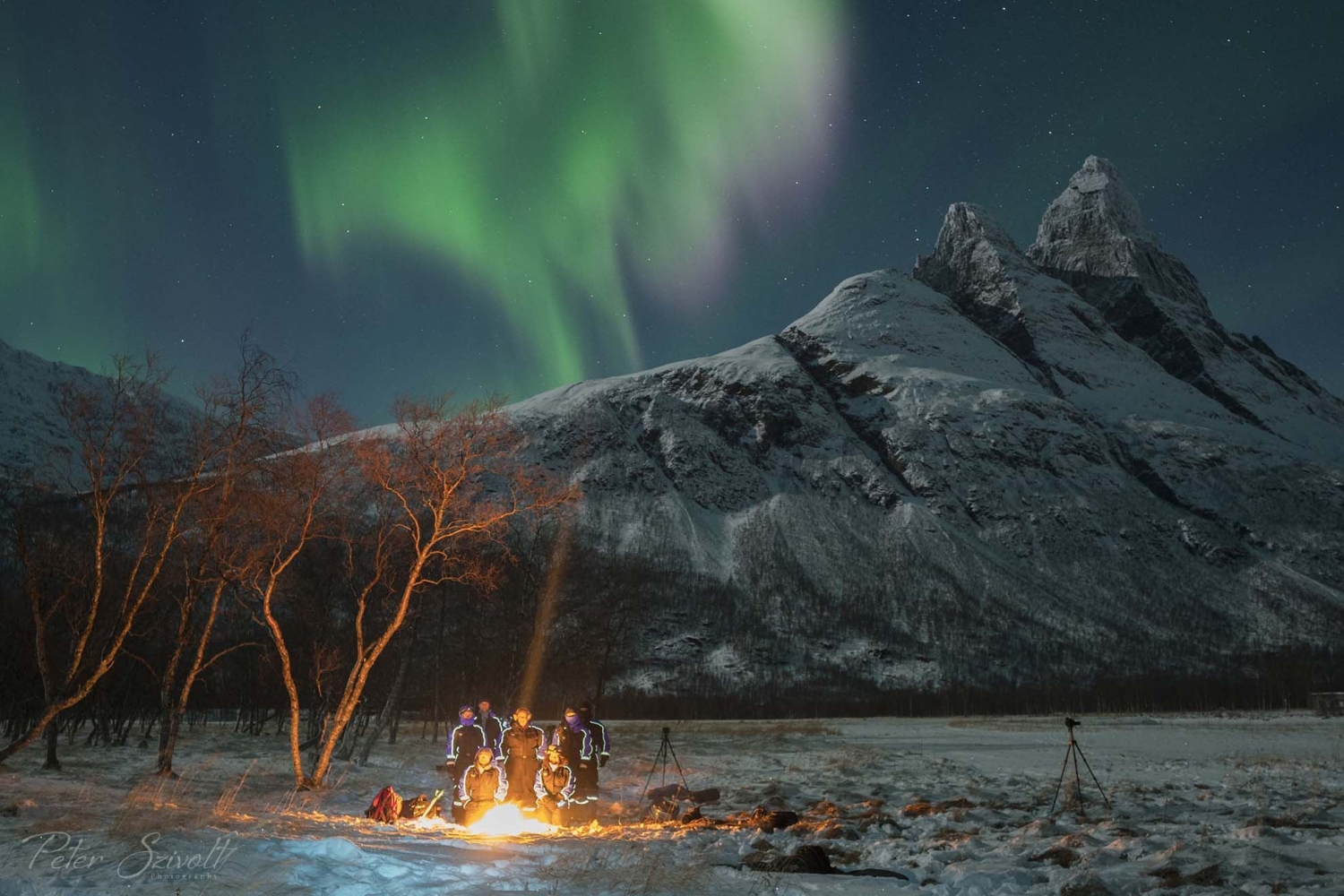 Northern lights, mountain and a bonfire